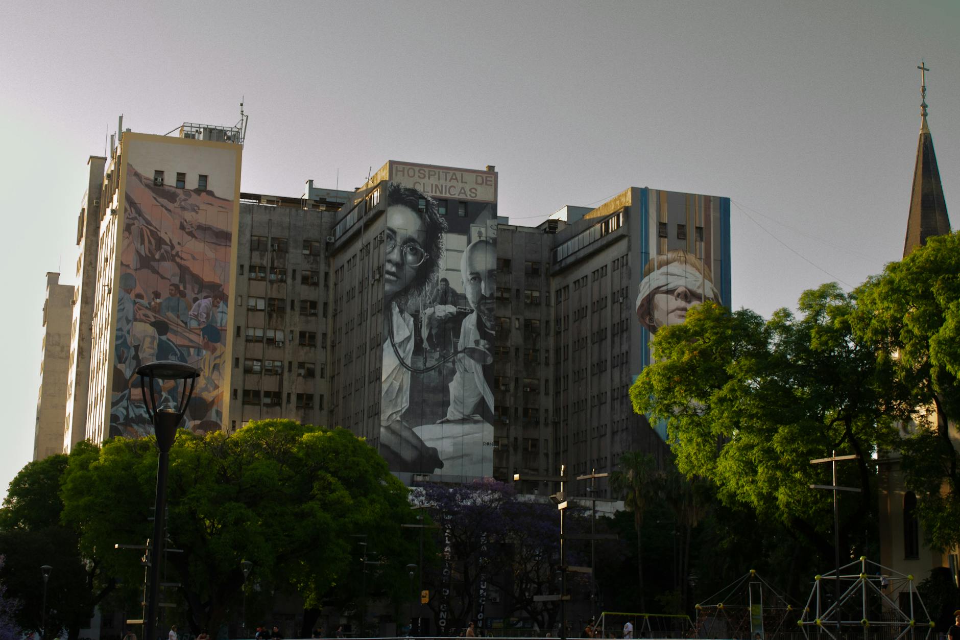 Hospital de Clínicas in Buenos Aires adorned with vivid murals, showcasing urban art.